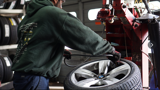 Technician mounting a tire on a BMW wheel